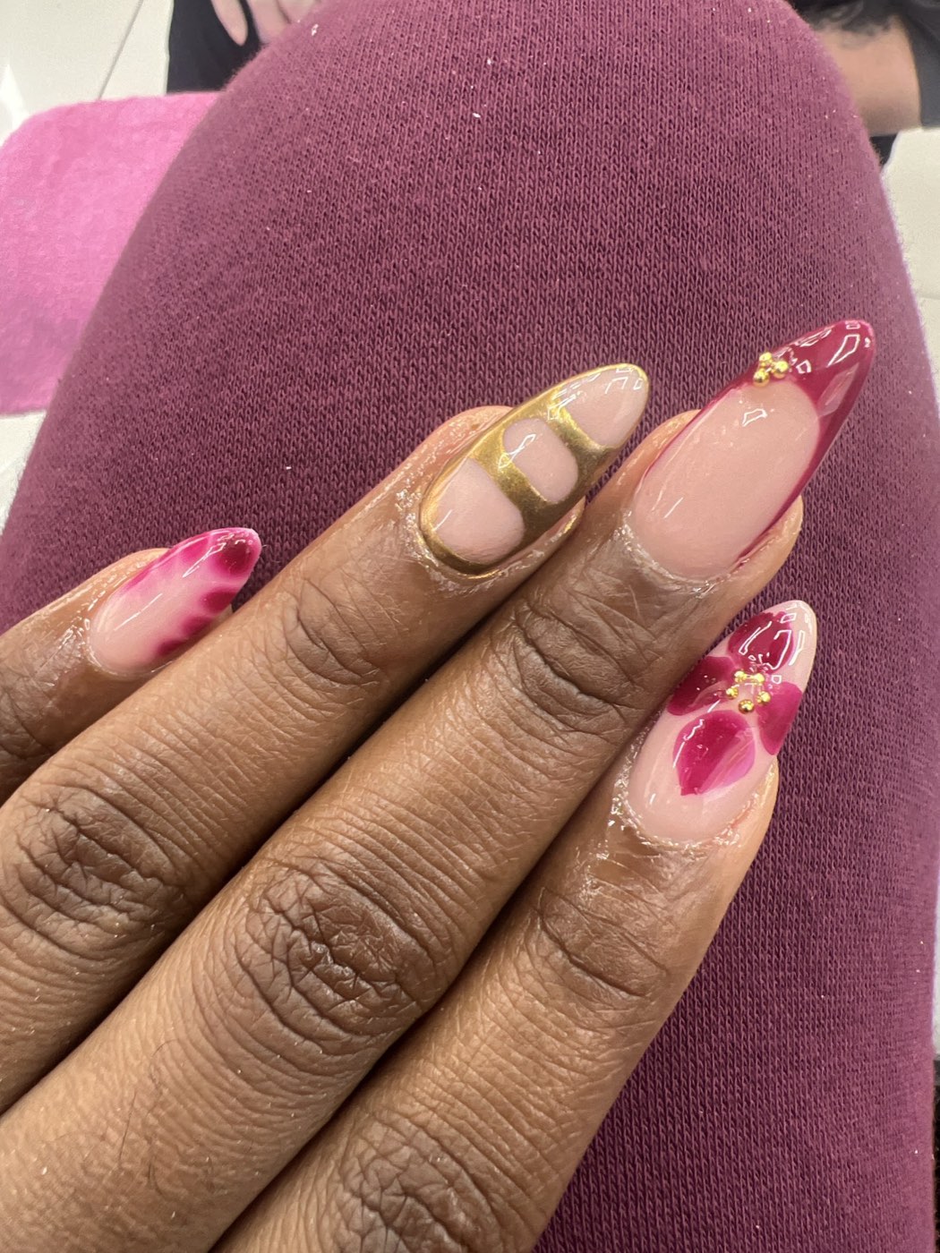 Almond nails with a hand-painted magenta 3D floral design and fine gold beading, created at Glamorous Nail Shop in Barking