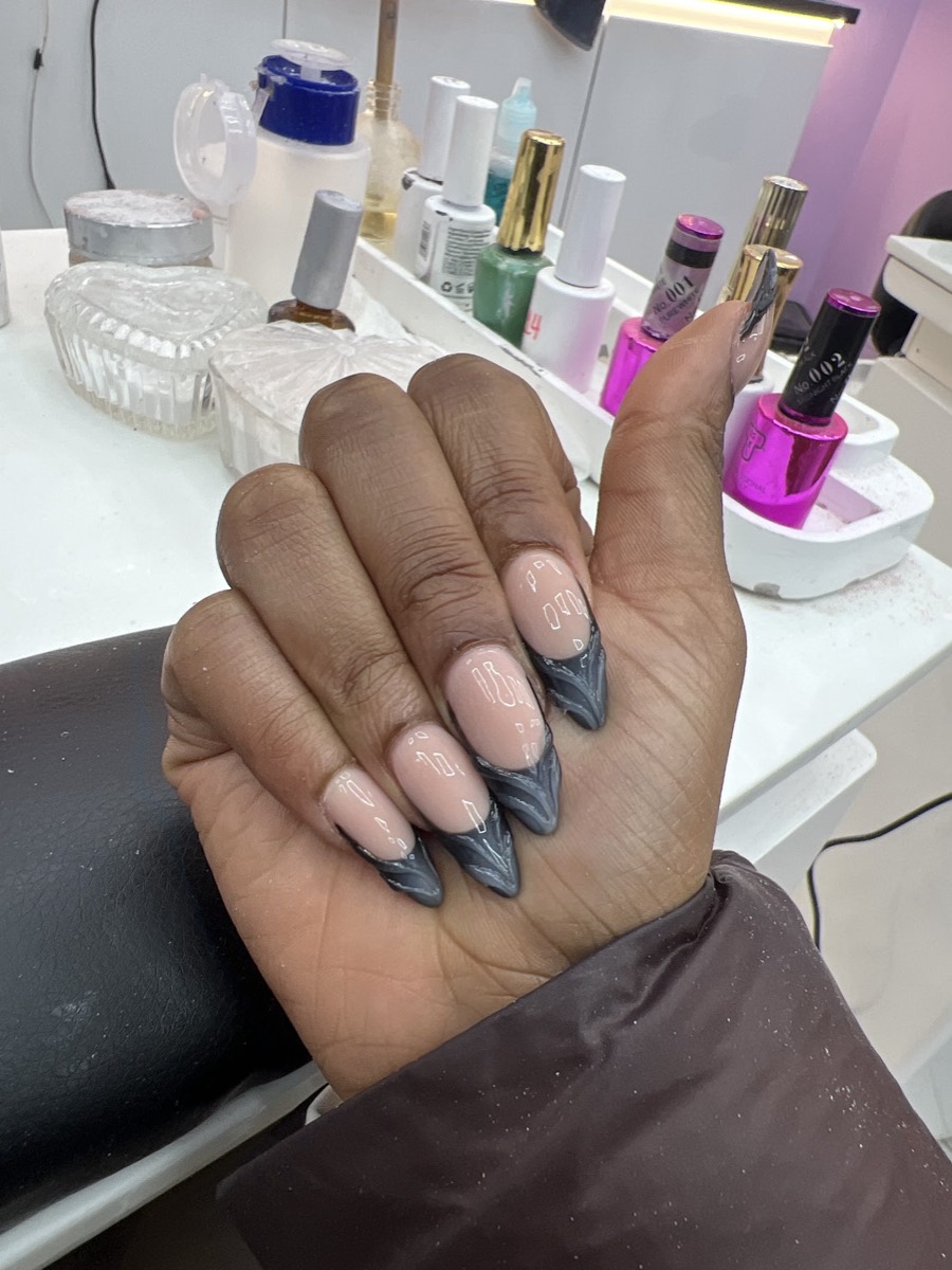 Grey marble stiletto nails at the Glamorous Nail Shop workstation